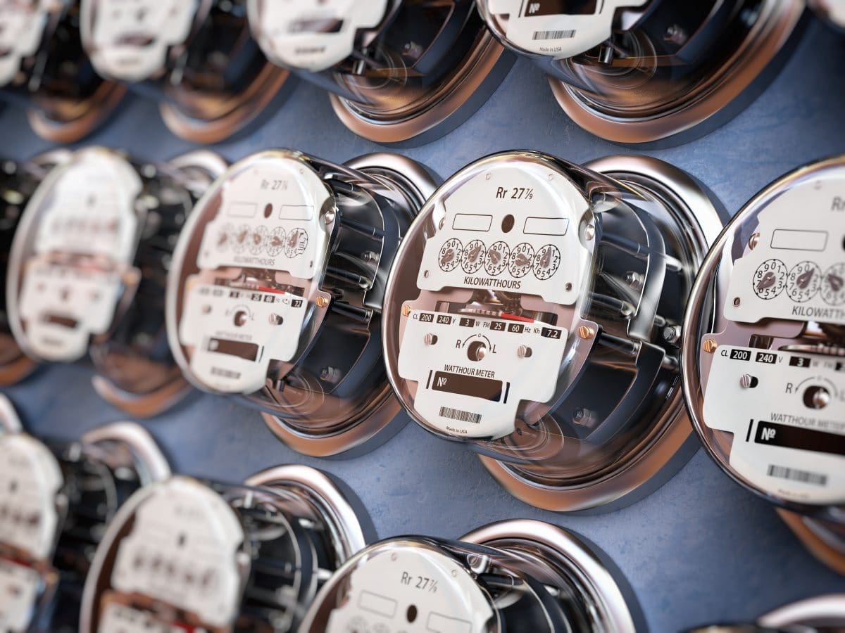 Electric meters in a row measuring power use. Electricity consumption concept.